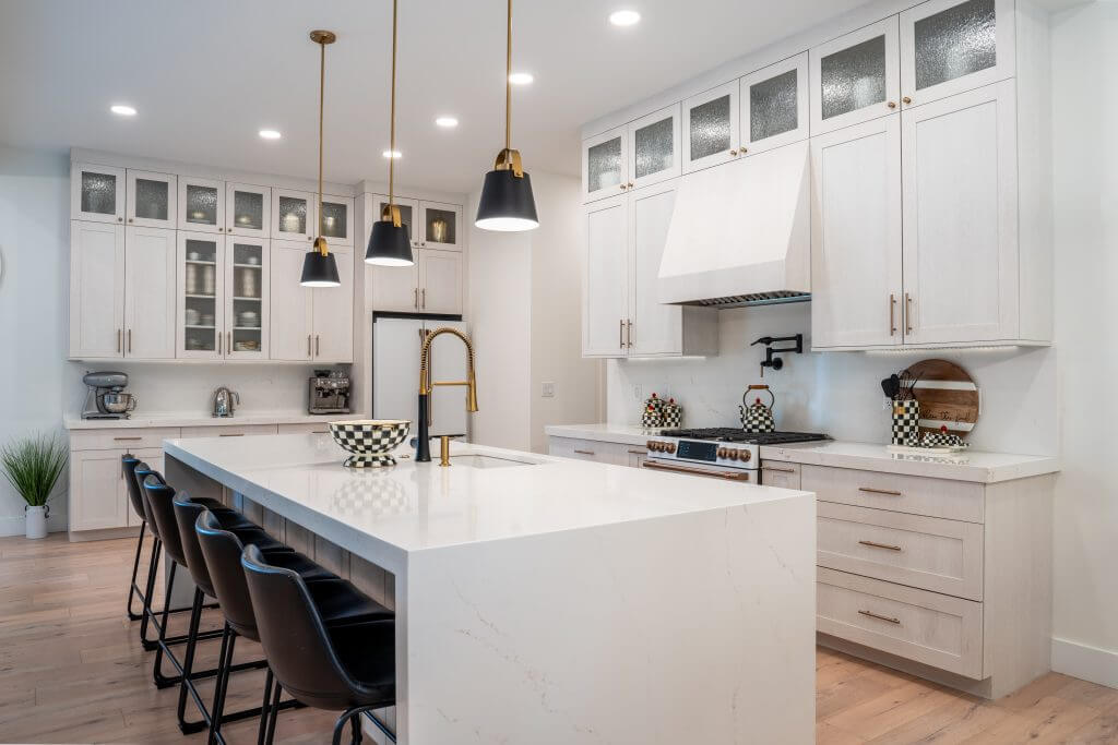 modern and newly remodeled kitchen with tall kitchen cabinets and white countertops