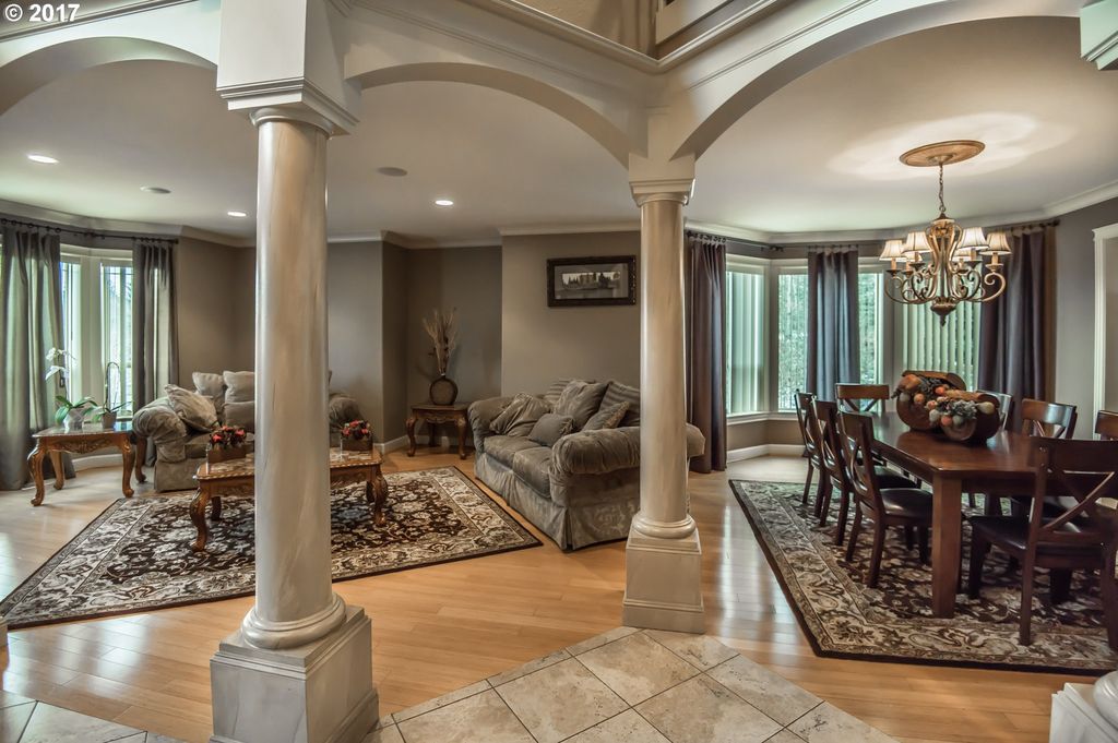 Sitting and dining area with pillars and moulding in this luxury custom built home
