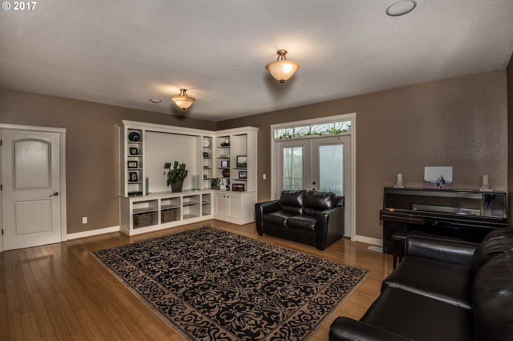 living room with brown flooring and brown walls