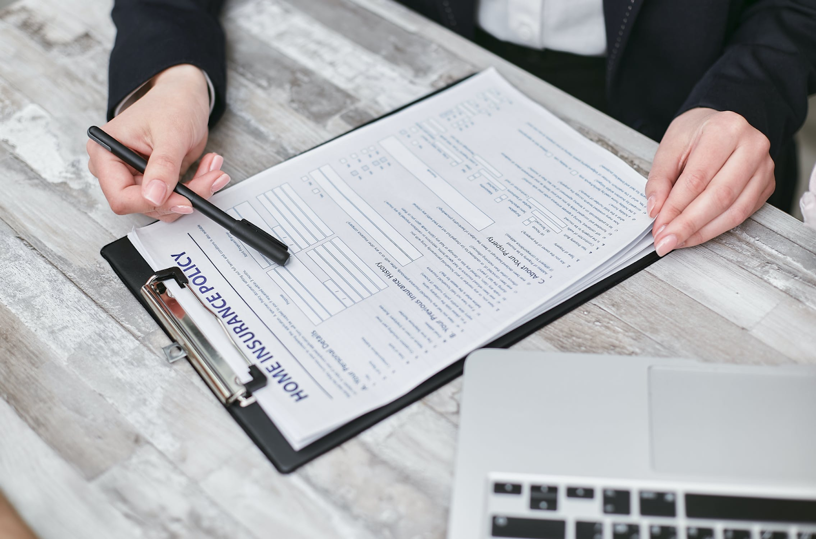 person filling out home insurance forms after getting water damage