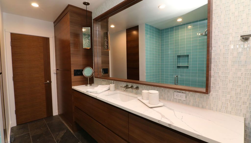 Modern bathroom remodel with in-set mirror framed by dark wood