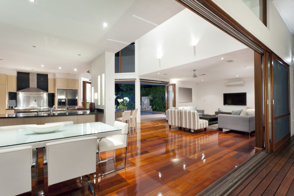 interior of a home with glossy hardwood floors and high ceilings