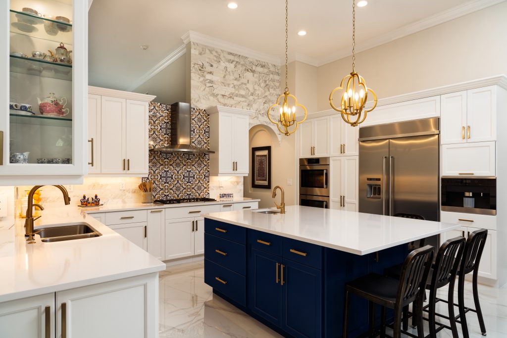 beautiful luxury kitchen with a large kitchen island and white cabinets