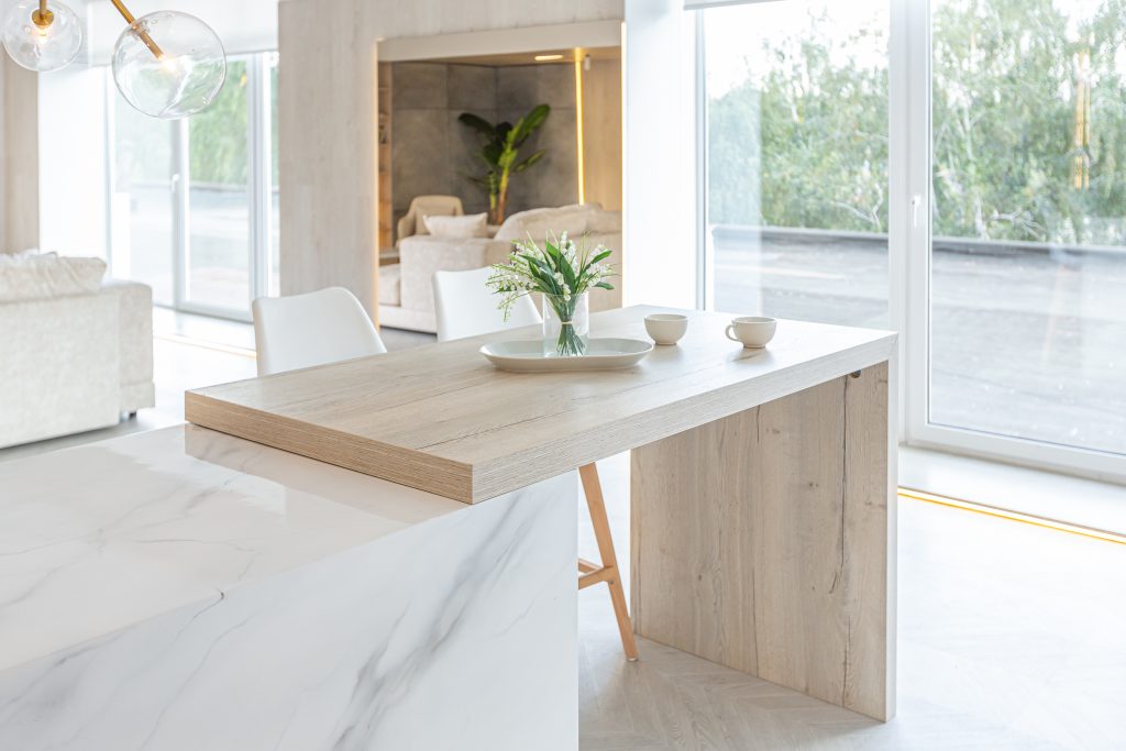 minimal modern clean kitchen with marble countertops and wooden details