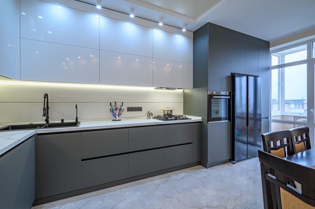 modern kitchen with gray flat-front cabinets and seamless silhouettes