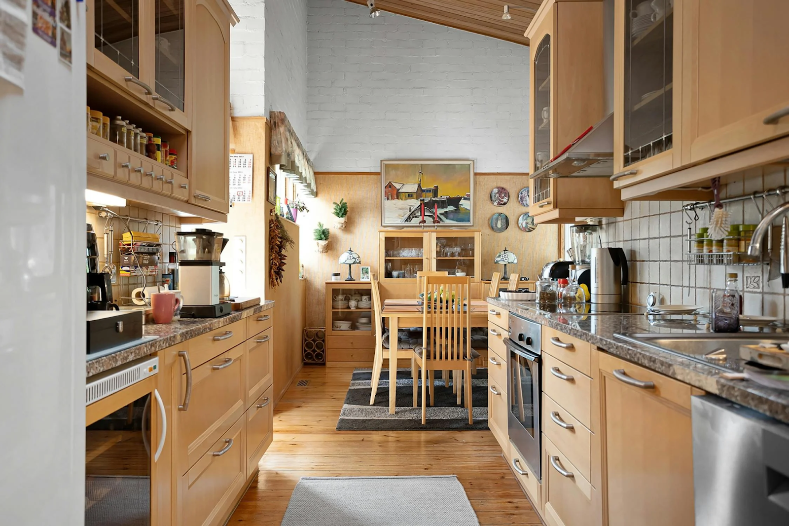 galley kitchen with lots of appliances and wooden cabinets