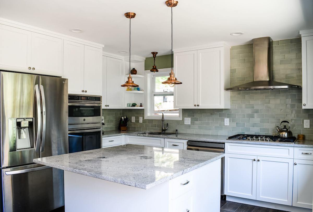 newly remodeled l shaped kitchen with an island and a hood