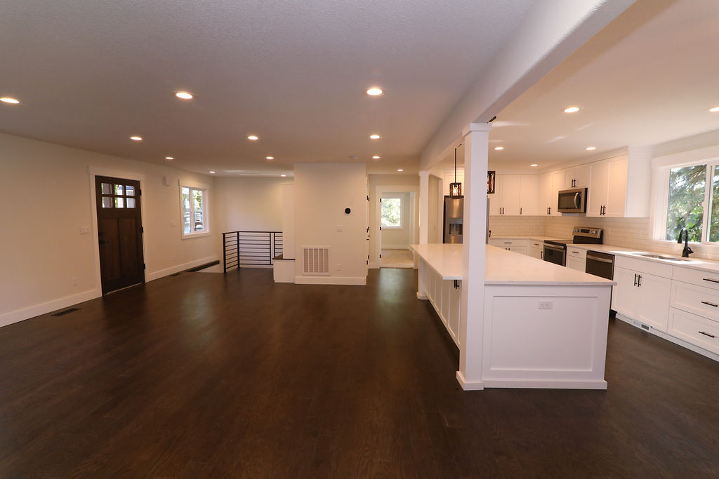 remodeled kitchen with white cabinets and black fixtures